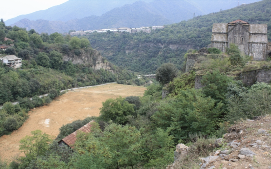 View of the Akhtala community with the abandoned tailing in the middle (monastery on the right)
