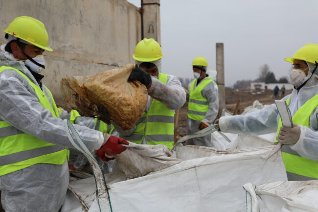 Workers in personal protective equipment clean site contaminated with DDT in Sangoba, Tajikistan, Environmental Health and Pollution Management Institute, EHPMI, Peshsaf