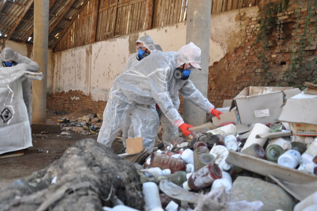 Workers in personal protective equipment clean site contaminated with DDT in Ziraki, Tajikistan, Environmental Health and Pollution Management Institute, EHPMI, Peshsaf