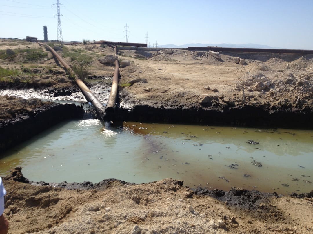 Settling pond of oily organic sludge